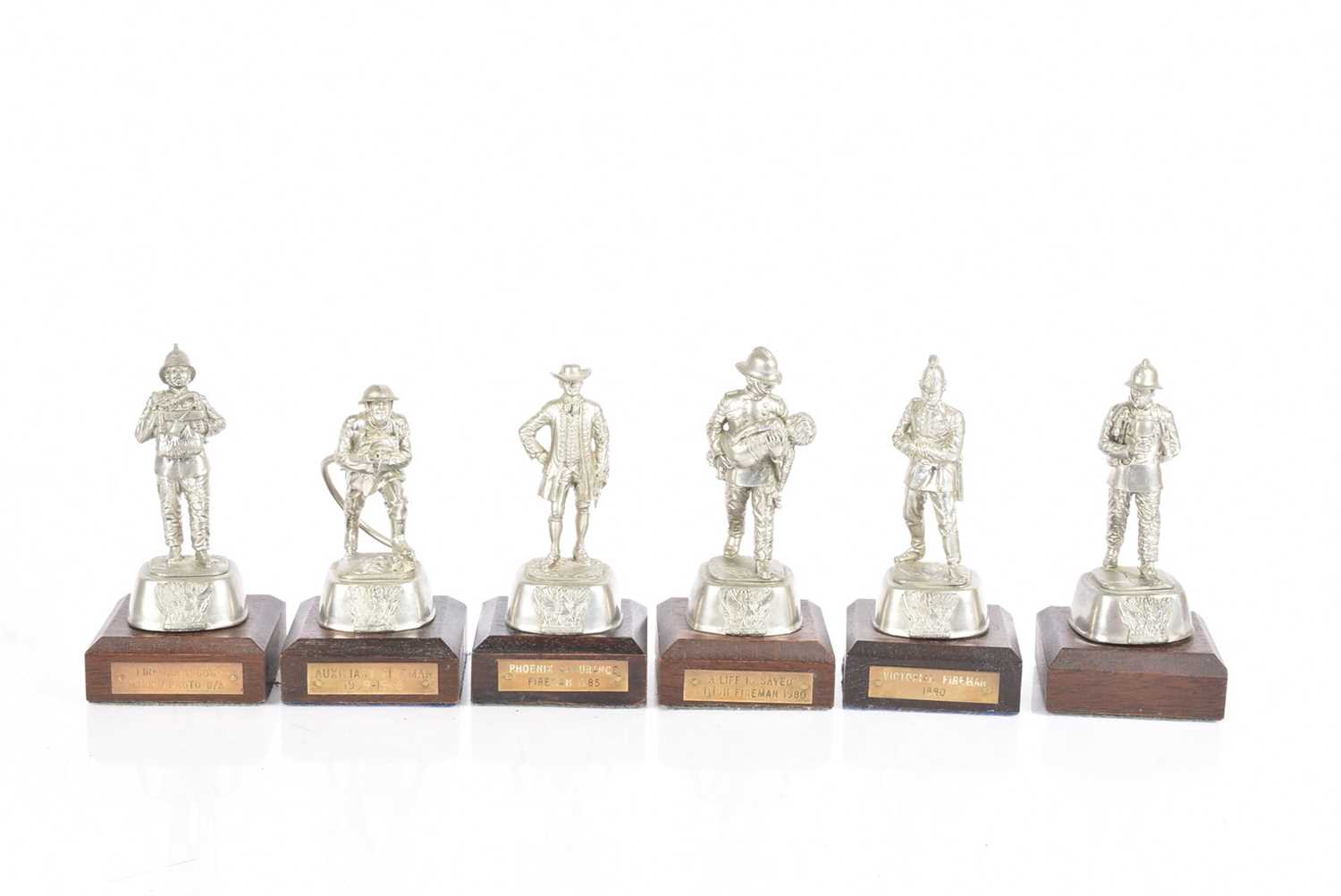Lot 51 - A group of six white metal Fireman Figures by Charles Staddon