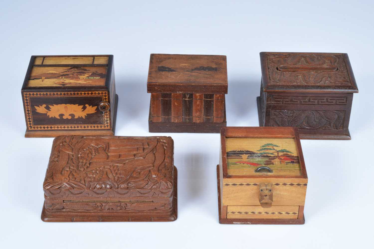 Lot 250 - A collection of five vintage middle and far eastern treen cigarette dispensers