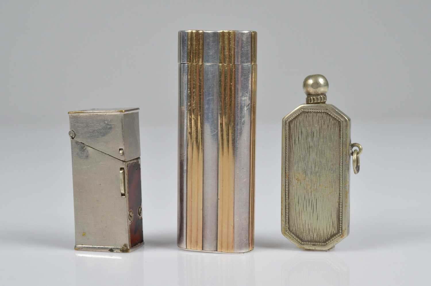 Lot 282 - A Cartier Ovale bi-metal pocket lighter