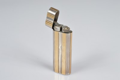 Lot 282 - A Cartier Ovale bi-metal pocket lighter