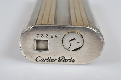 Lot 282 - A Cartier Ovale bi-metal pocket lighter