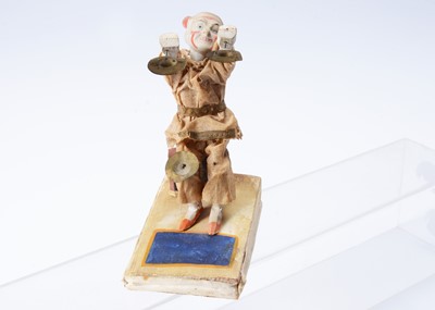 Lot 210 - A mid to late 19th century Thüringen white faced clown squeak toy