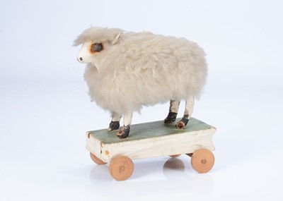 Lot 221 - An 19th century German papier-mâché sheep on wheels squeak toy