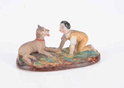 Lot 487 - An 19th century German bisque miniature or dolls’ house figure of a boy and dog