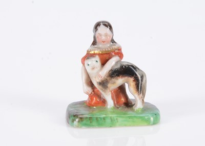 Lot 488 - An 19th century German porcelain miniature or dolls’ house figure of a girl with cat