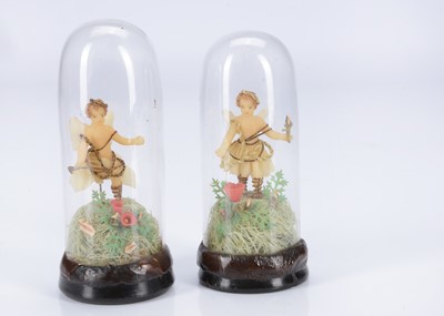 Lot 496 - A rare pair of 19th century wax cherub figures under glass domes