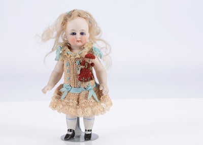 Lot 500 - A small late 19th century German  all-bisque doll