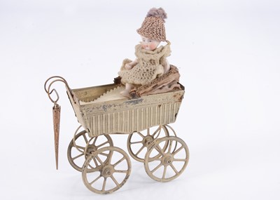 Lot 502 - A small Goso painted tinplate perambulator with all-bisque baby