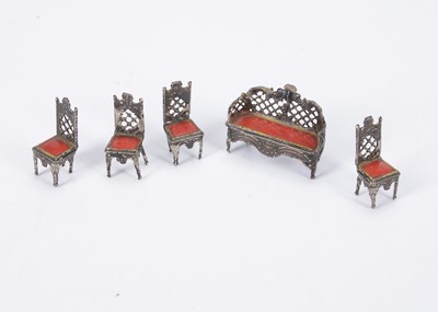 Lot 547 - A rare 19th century German very small scale soft metal dolls’ house sofa and chairs