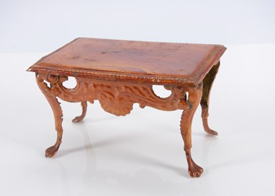 Lot 563 - A rare 19th century Evans and Cartwright painted tinplate dolls’ house console table