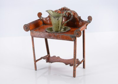 Lot 565 - An 19th century Evans and Cartwright painted tinplate dolls’ house washstand