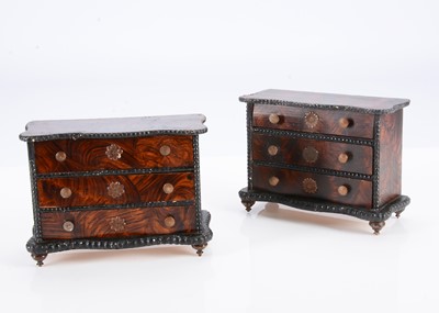 Lot 566 - A pair of 19th century German wood grained dolls’ house chest of drawers
