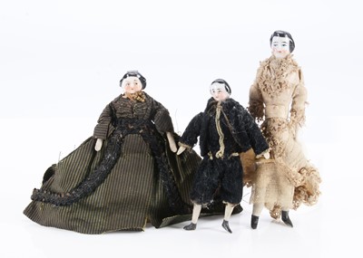 Lot 674 - Three late 19th century china shoulder-head dolls’ house dolls