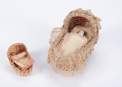 Lot 689 - An 19th century dolls’ house pink wicker cradle