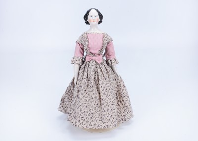 Lot 860 - An 19th century German slight pink tinted china shoulder head doll with elaborate hair style