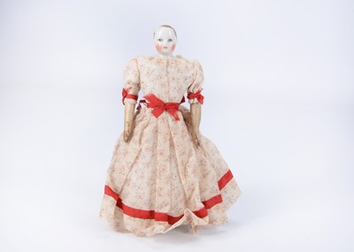 Lot 870 - A small 19th century French china shoulder-head fashion doll