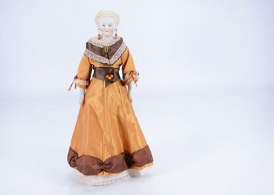 Lot 872 - An 19th century German bisque shoulder head doll with elaborately moulded hairstyle