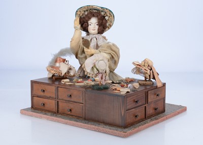 Lot 880 - A Sands Film or television theatrical property doll with milliner stall