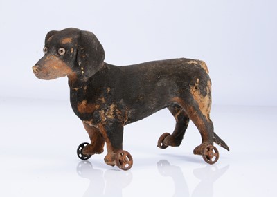 Lot 931 - A late 19th century dachshund on wheels