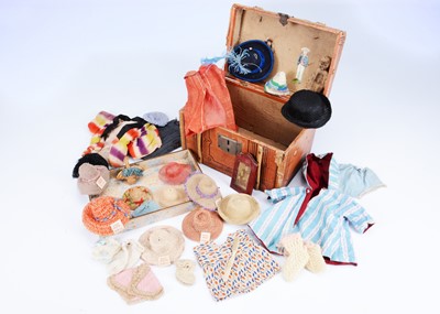 Lot 954 - A selection on early 20th century small doll's clothes with trunk