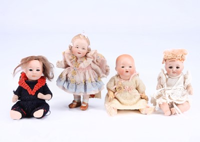 Lot 985 - Four small character baby dolls