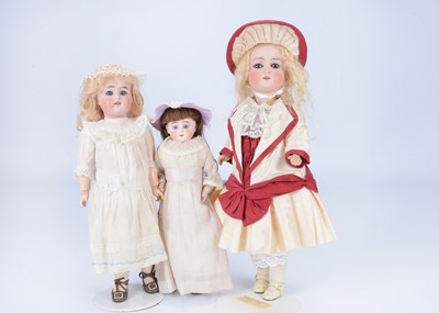 Lot 1011 - Three small bisque headed child dolls