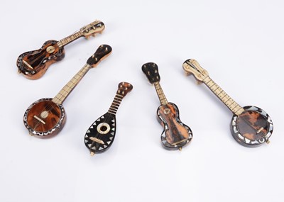 Lot 1042 - Five miniature string instruments for dolls