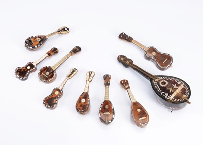Lot 1044 - Nine miniature string instruments for doll's