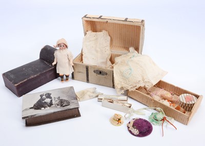 Lot 1058 - A small 19th century doll's domed trunk and contents