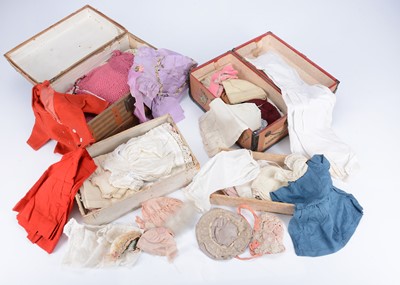 Lot 1075 - Two early 20th century canvas covered cross-banded wooden doll’s trunks and contents