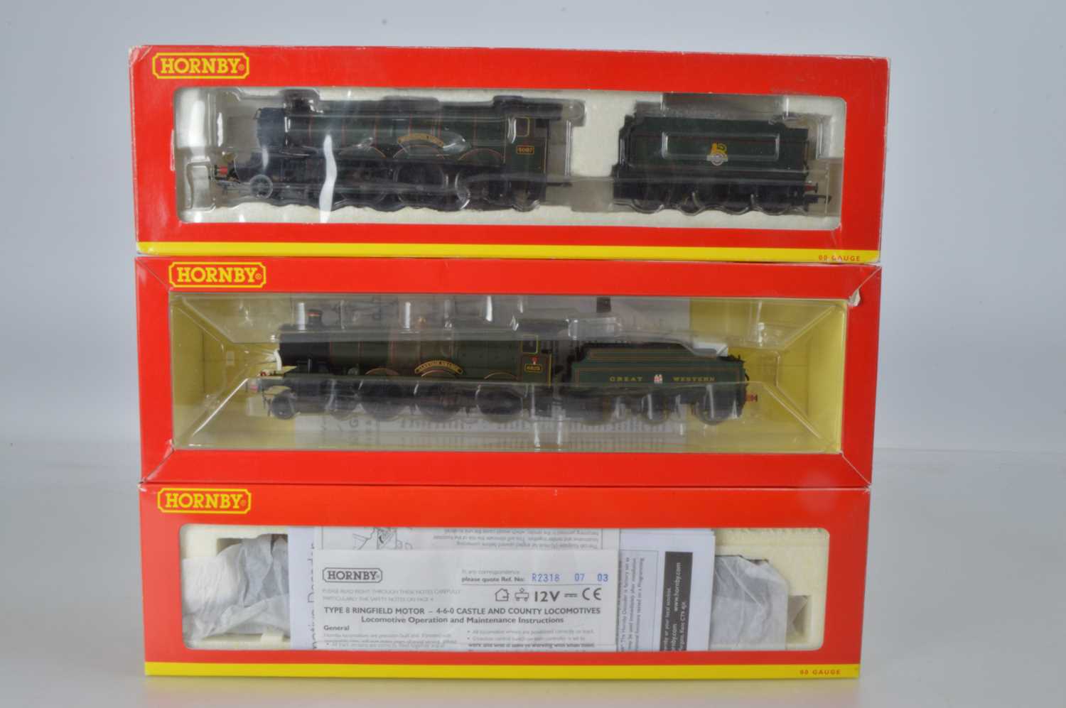 Lot 37 - Hornby (China) boxed 00 Gauge GWR green Grange and BR green Castle Class Locomotives and Tenders (3)