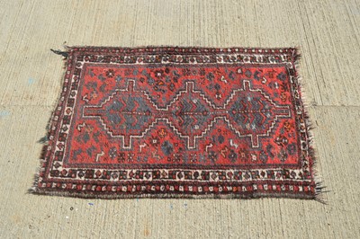 Lot 858 - A small crude woollen rug