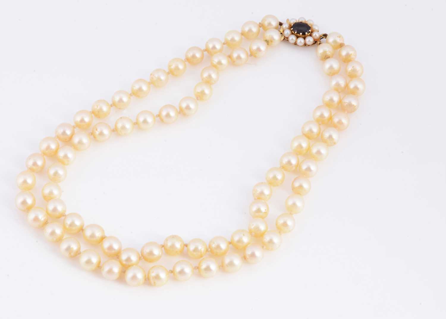 Lot 5 - A double row cultured pearl necklace with 9ct gold pearl & garnet set clasp