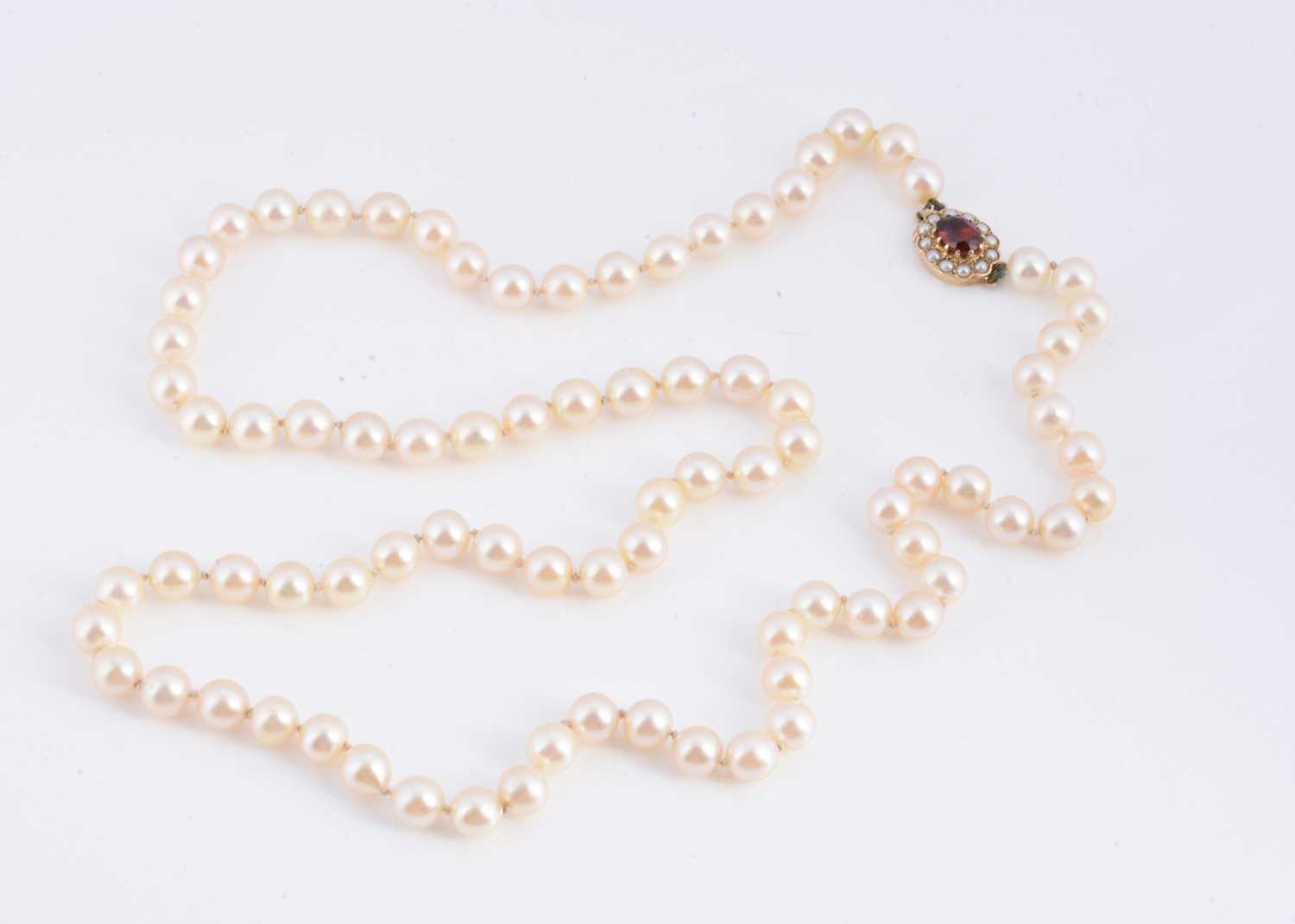 Lot 14 - A uniform knotted cultured pearl necklace, with 9ct gold clasp
