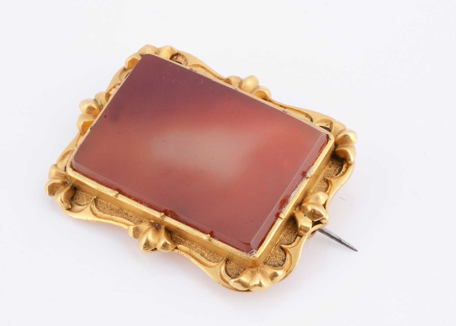 Lot 22 - An antique carnelian gilt framed brooch