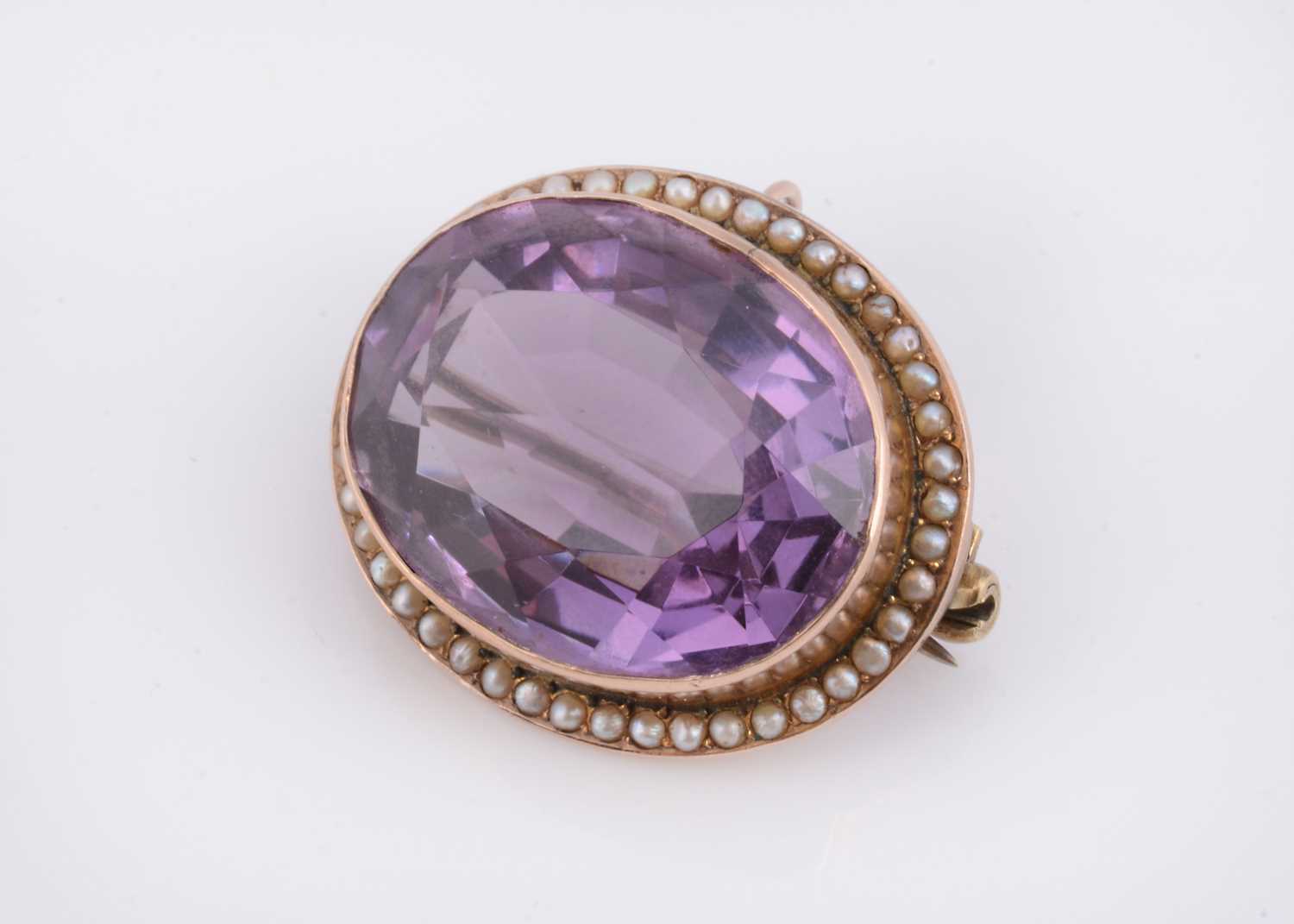 Lot 32 - An antique yellow metal amethyst & seed pearl brooch