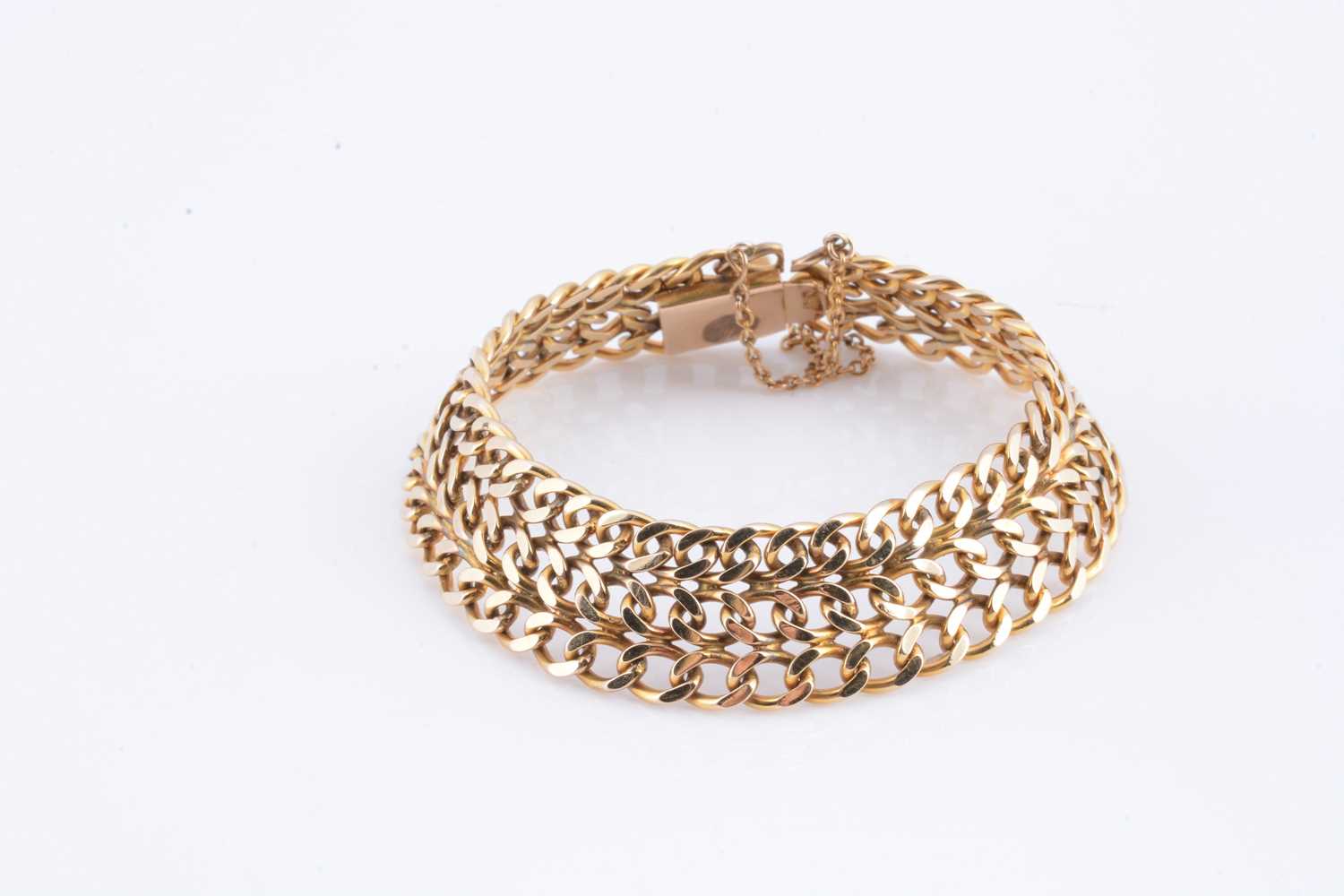 Lot 36 - A yellow metal gold three strand curb bracelet