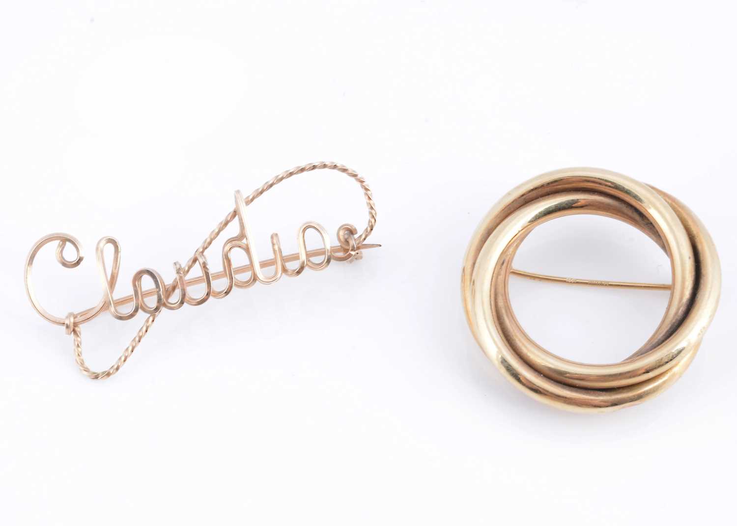 Lot 56 - A yellow metal circular twist brooch