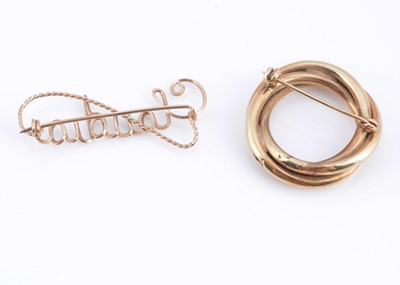 Lot 56 - A yellow metal circular twist brooch