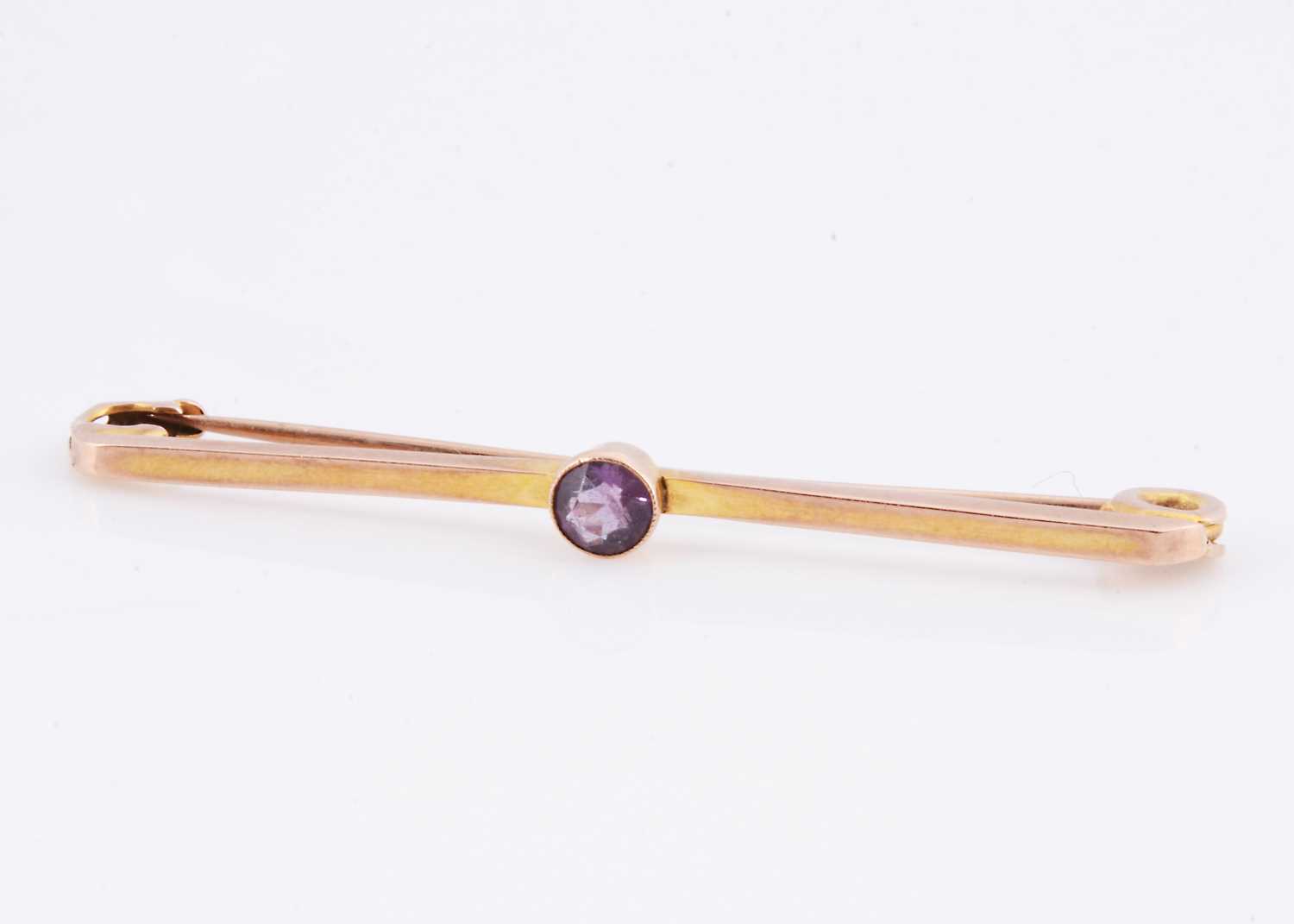 Lot 69 - An Art Deco amethyst 9ct gold bar brooch