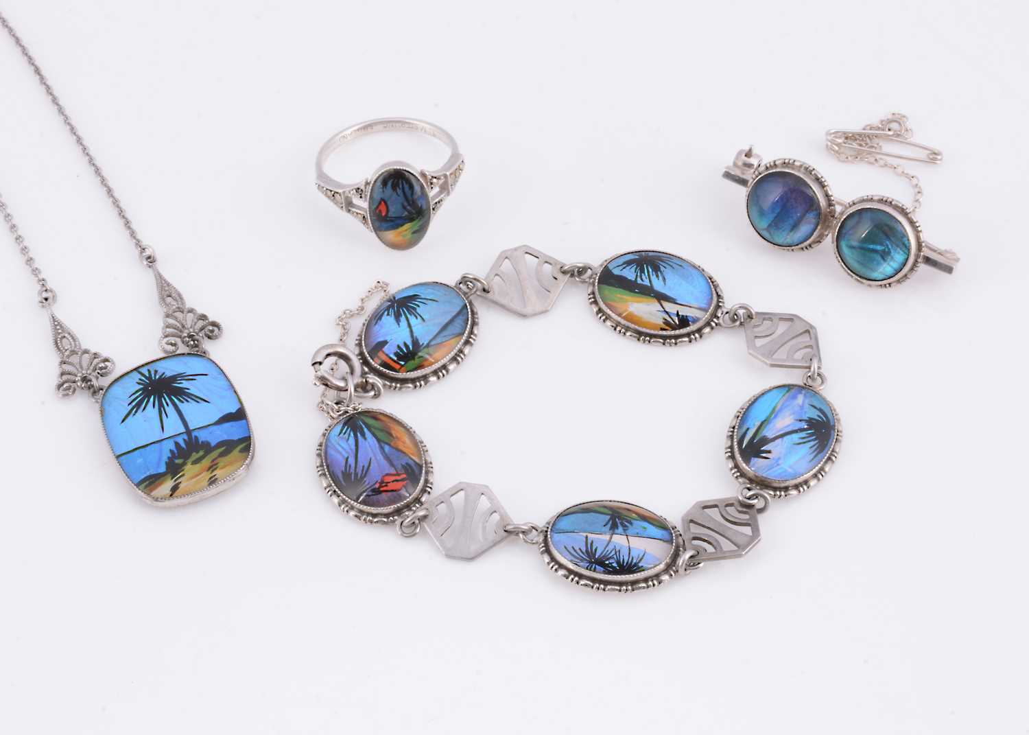 Lot 72 - An Art Deco set of Thomas L Mott reverse painted butterfly wing silver jewellery