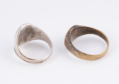 Lot 79 - A white metal signet ring & a brass example