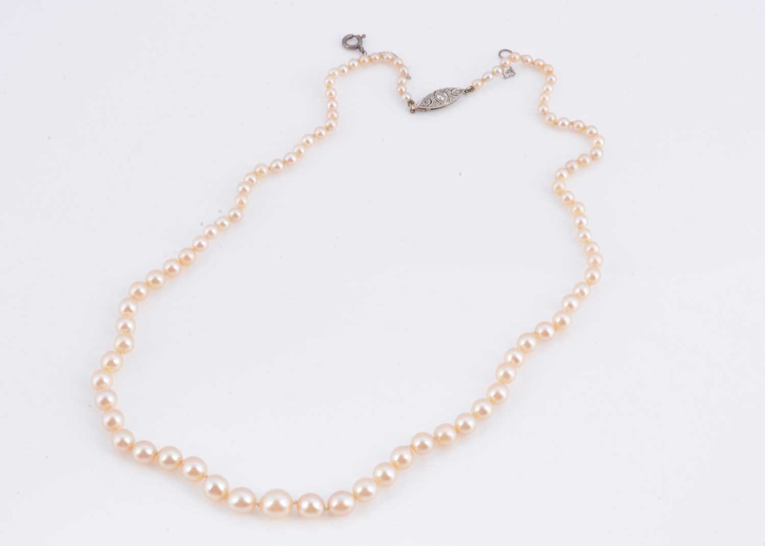 Lot 94 - A string of graduated cultured pearl necklace, with diamond set clasp