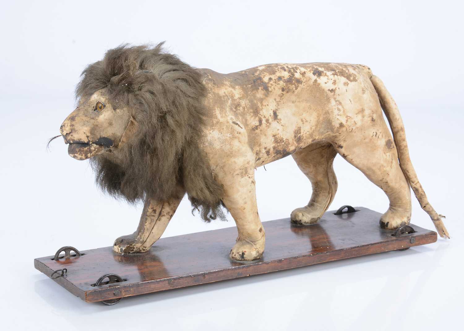 Lot 26 - An 19th century skin covered nodding lion on wheels
