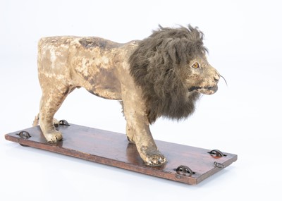 Lot 26 - An 19th century skin covered nodding lion on wheels