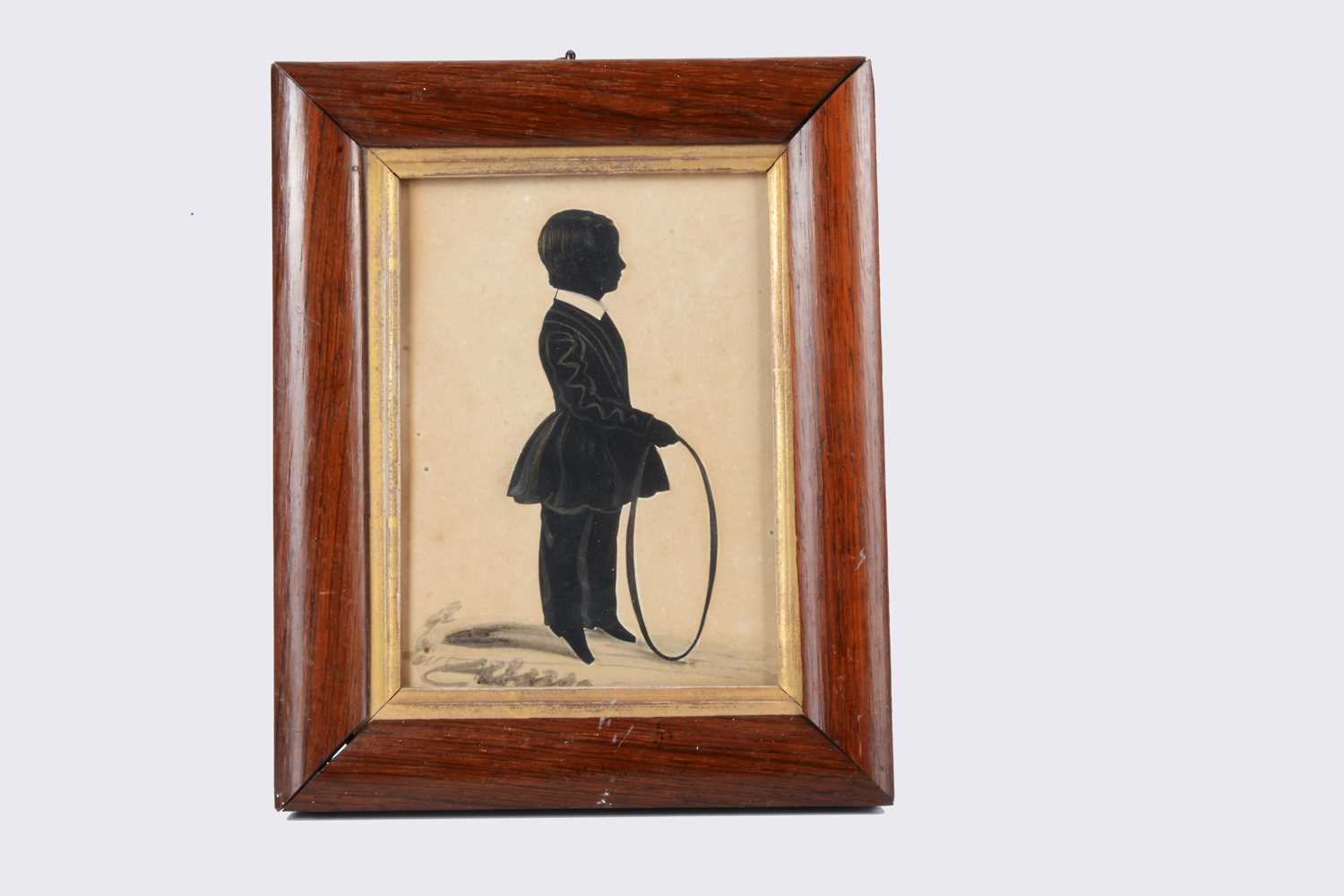 Lot 42 - An 19th century J Moore of Nottingham cut-paper silhouette of a boy with toy hoop