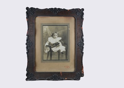 Lot 70 - A very large studio photograph of a young child holding a teddy bear, circa 1910