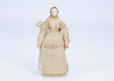Lot 114 - An 19th century German bisque shoulder head doll with rare ‘sampler’ aprons