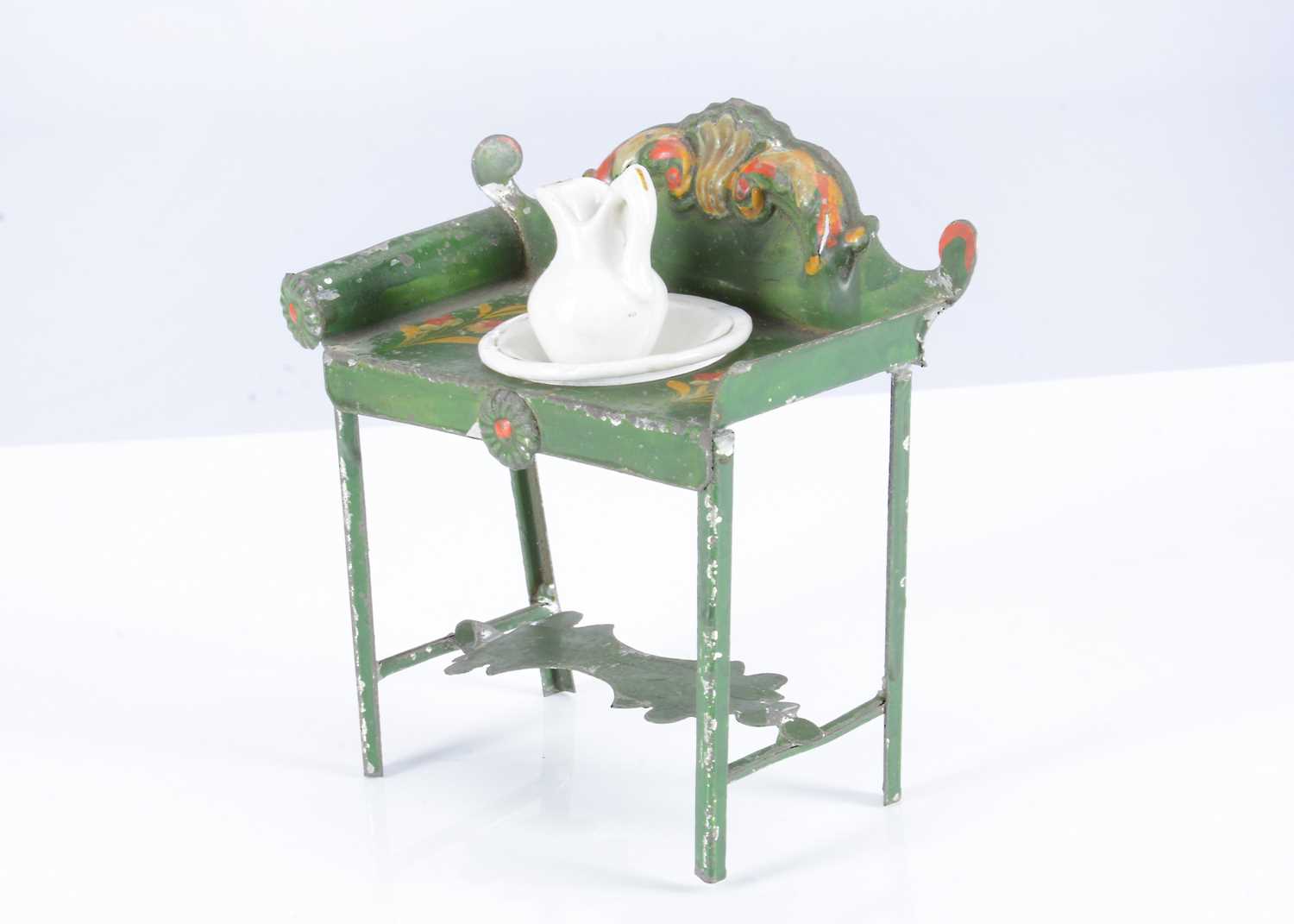 Lot 117 - A rare early 19th century Evans & Cartwright green painted tinplate dolls’ house washstand