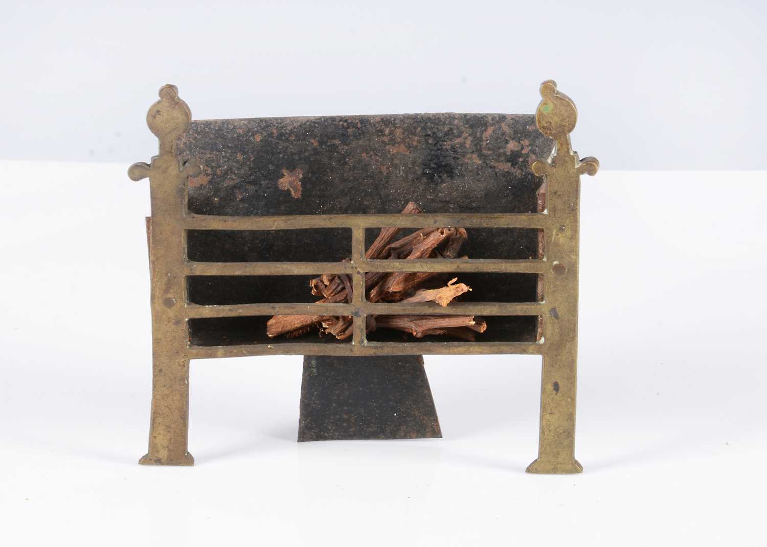 Lot 122 - An early English brass dolls’ house fire grate